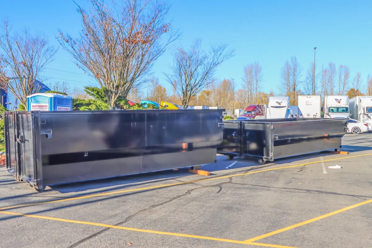 Professional dumpster rental service with roll-off container on residential driveway in Des Plaines